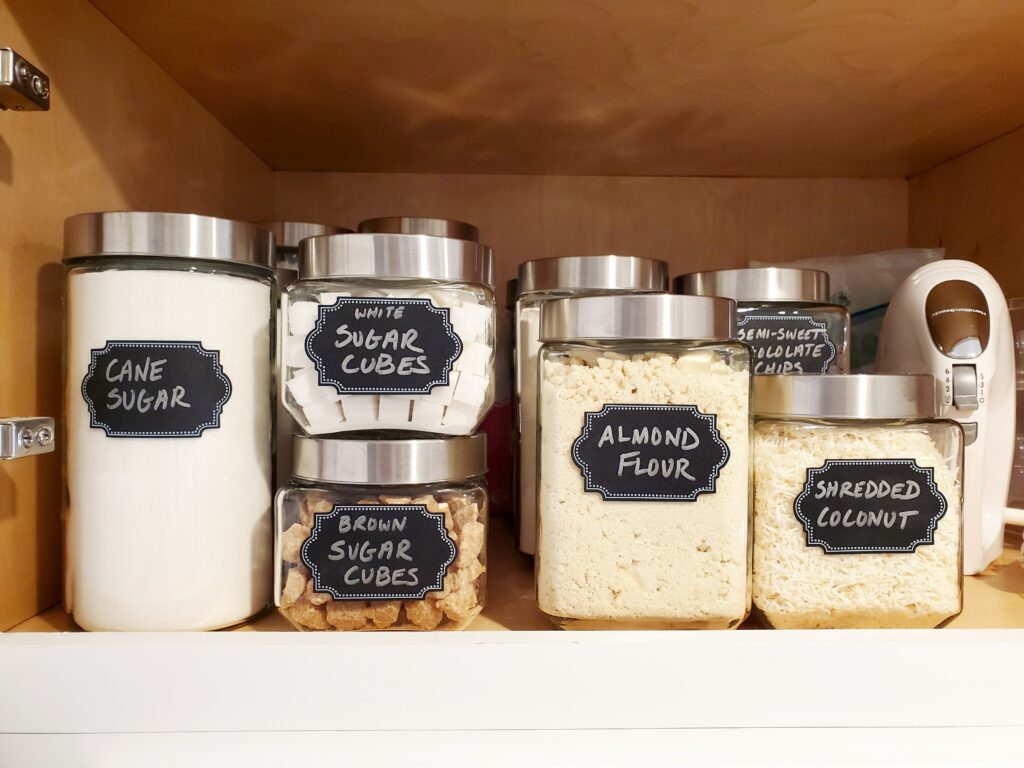 kitchen and pantry food glass jars and metal lids with black chalk labels Bella Organizing Professional home organizers and residential packing and moving management company serving the San Francisco Bay Area.