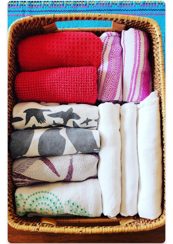 kitchen unpack tea and dish towel file fold in basket Bella Organizing Professional home organizers and residential packing and moving management company serving the San Francisco Bay Area.