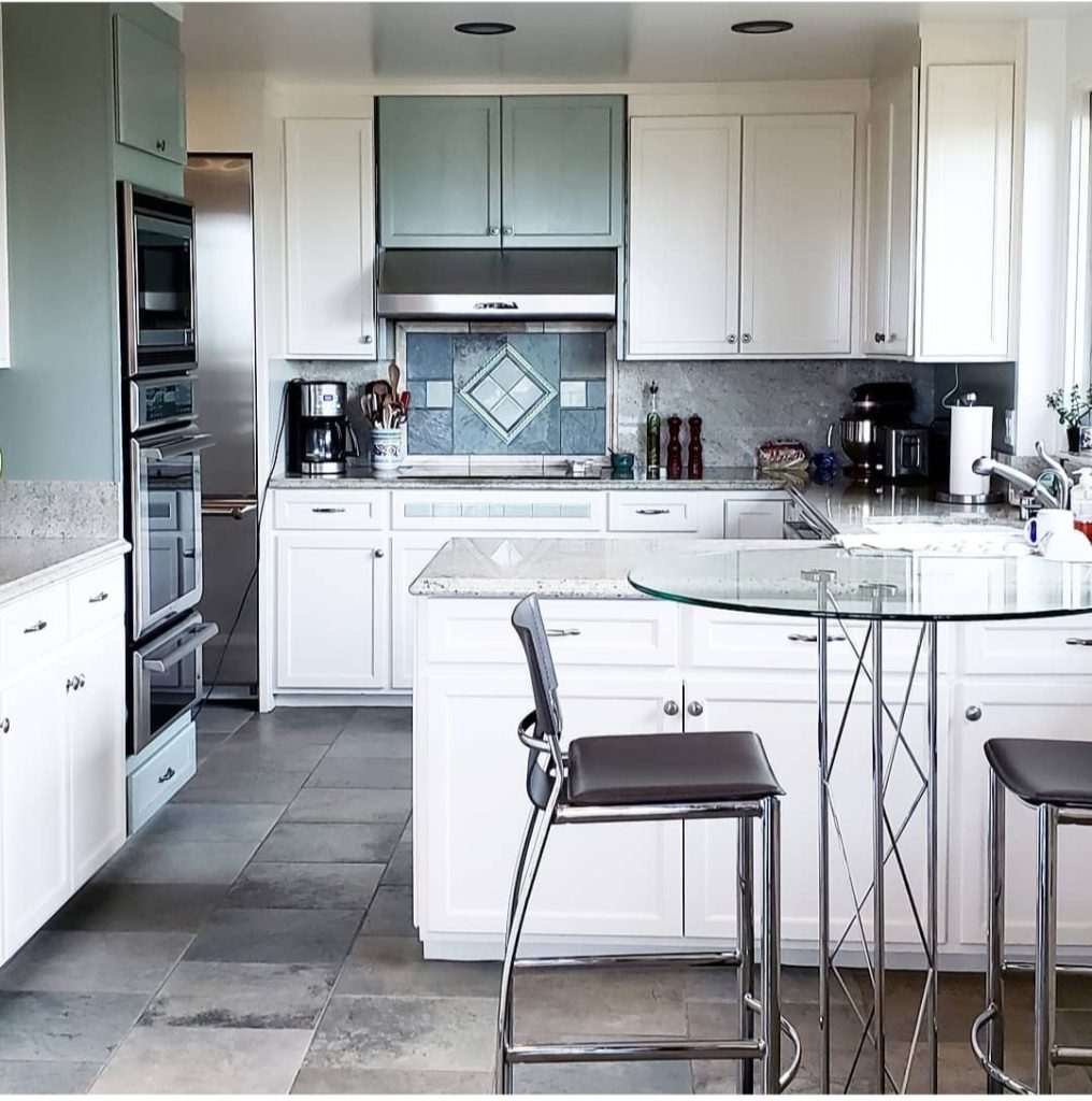 unpack and organize white kitchen with glass bistro table and tall chairs Bella Organizing Professional home organizers and residential packing and moving management company serving the San Francisco Bay Area.