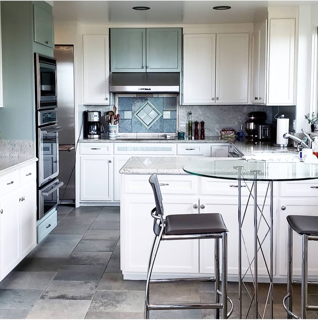 unpack and organize white kitchen with glass bistro table and tall chairs Bella Organizing Professional home organizers and residential packing and moving management company serving the San Francisco Bay Area.